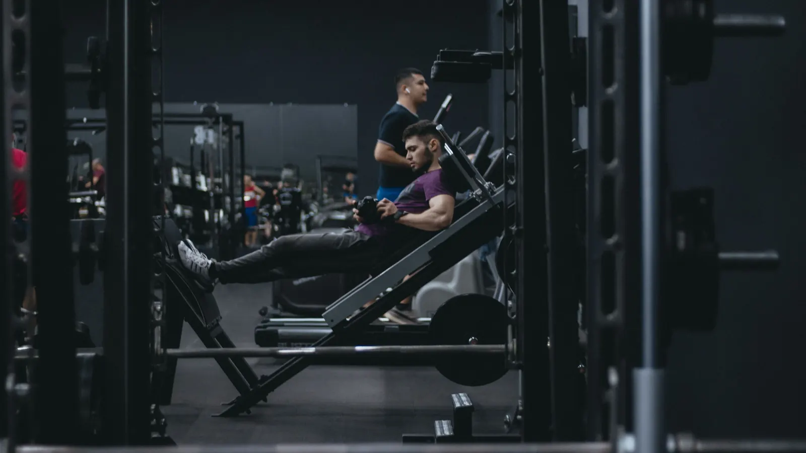 Man using a leg press machine in a gym